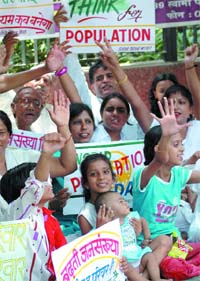 Members of Surabhi Parivar, an NGO, hold a demonstration to create awareness on the rising population on the eve of World Population Day at Jantar Mantar in  New Delhi on Thursday