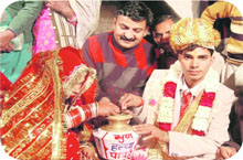 A couple takes a vow against female foeticide during marriage ceremony as Shyam Sunder (centre) looks on. A Tribune photograph