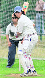 A Kashmiri college student plays a shot during net practice at a cricket camp in Srinagar on Thursday.