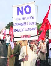 An activist from the CPM holds a placard during a protest against the nuclear deal with the US in Kolkata on Thursday.