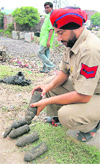 A policeman inspects shells found near the Anngarh area in Amritsar 