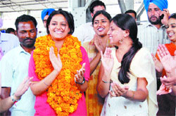 A BBK College girl receives a warm welcome on her return from China at Amritsar railway station