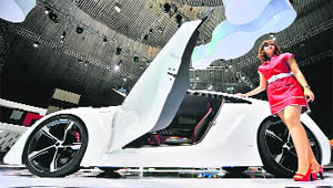 A model stands next to a hybrid concept car at the 16th Indonesia International Motor Show in Jakarta on Friday.
