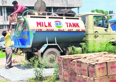 Employees of the excise and taxation department unload cases of beer seized from a milk tanker at Panchkula on Friday