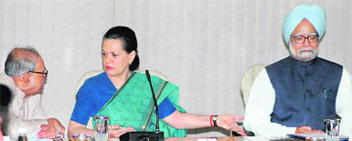 Manmohan Singh appears to be quietly soaking it in as Pranab Mukherjee and Sonia Gandhi talk to each other at the Congress Working Committee meeting in New Delhi on Friday.