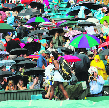 Serena Williams leaves the court after rain interrupted her semi-final match against China's Zheng Jie. She and her sister Venus reached the final in their own contrasting styles proving what magnificent athletes they are 