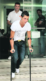 Portugal's soccer player Cristiano Ronaldo leaves after a treatment session of his injured right ankle at a physiotherapy centre in Lisbon on Friday. 
