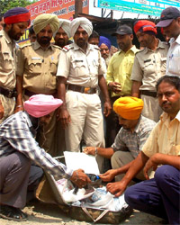 Police officials checking an unclaimed suitcase at Bathinda bus stand on Saturday.