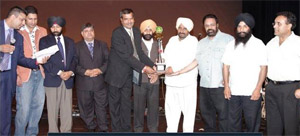 Ashok Bansal receiving the honour.