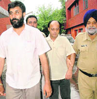 Gurginder Pal Singh and Upjeet Singh in police custody in Chandigarh on Saturday. Tribune photo: Manoj Mahajan