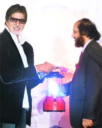 Amitabh Bachchan (left) being presented with a solar lantern by Nobel Laureate R.K. Pachauri after he along with other stars pledged their support to the 'Light a Billion Lives' campaign, an initiative of the Energy Resource Institute of India headed by Pachauri, in Mumbai