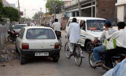 Free For All: Wrong parking and encroachments on the Mela Ram road continues unabated creating problems for motorists and commuters. 