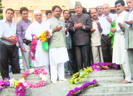 Azad along with others offers prayers at the martyrs graveyard at the Naqshband Sahib shrine in Srinagar on Sunday.