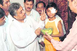 Minister for medical education and research Tikshan Sood distributes fruits to patients having undergone eye surgery at an eye bank in Ludhiana on Sunday.