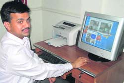 Kapurthala SSP Rakesh Aggarwal monitors CCTV camera footage in his office.