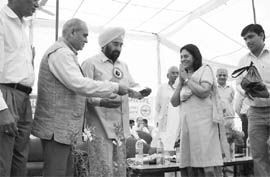 Shashi Sabharwal is being honoured by Haryana agriculture minister Harmohinder Singh Chatha at a function.