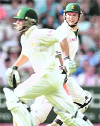 South African captain Graeme Smith (R) runs beween the wickets with team-mate Neil McKenzie as they bat against England at Lords, on the fourh day of the first Test