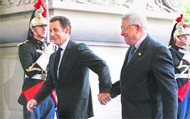 Palestinian President Mahmoud Abbas (right) is greeted by France President Nicolas Sarkozy as he arrives at the EU-Mediterranean summit in Paris on Sunday. Some 43 heads of state and government are attending the French-inspired summit intended to revitalise cooperation between the European Union and Mediterranean countries. 