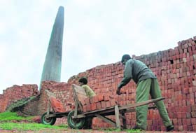 A labourer and his daughter work in a brick kiln in Karnal