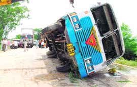 A Haryana Roadways bus which overturned on National Highway No. 10 near Rohtak on Monday. Ten passengers were injured in the mishap.