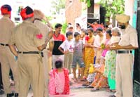 Residents of Laxmi Nagar stage a dharna in front of Sky Way Senior Secondary School in Ludhiana on Monday.