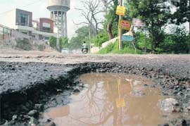 A portion of road in the Rajguru Nagar area that has been washed away due to heavy rains in Ludhiana.