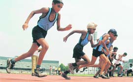 Students take part in athletics trials at Guru Nanak Stadium in Ludhiana on Monday.