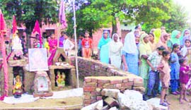 UNDETERRED FAITH: Devotees participate in a havan after the reconstruction of the temple in Malerkotla on Sunday. 