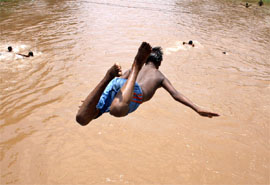 Finding no respite in the scorching summer, a boy is seen jumping into the cool waters of the Sirhind canal to cool himself in Bathinda on Tuesday.