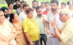 Prof Naval Kishore, director (sports), tries to pacify the agitated parents in Panjab University, Chandigarh,