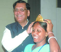 Bindeshwar Pathak, founder of Sulabh International, an NGO, helps Usha Chaumer, president of Shulabh International Social Service Organisation, wear a crown in New Delhi on Tuesday. The crown was presented to her by Vijay Nambiar, Chief of the Cabinet of UN Secretary-General during her visit to UN in New York on the occasion of International Year of Sanitation-2008.