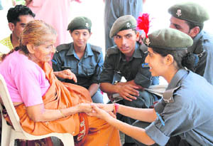 Air wing cadets of the NCC interact with an elderly woman at an old-age home in Karnal on Tuesday. 