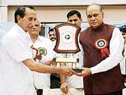 Chief Minister P.K. Dhumal receives a memento during a function of the Himachal Pradesh State Pensioners Welfare Association at Hamirpur on Tuesday.
