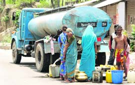 People draw water from a tanker to perform domestic chores at Domel in outskirts of Jammu on Tuesday