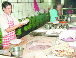 A cook prepares a tandoori roti at New Manni Dhabha in Jalandhar.
