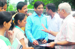 Dean Prof Naval Kishore talks to ABVP students after they scuffled with SOPU activists at PU, Chandigarh, on Wednesday.