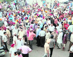 Residents block traffic at Partap Chowk in Ludhiana on Wednesday.