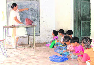 An aanganwari worker teaches poor children at a centre in Ludhiana. 