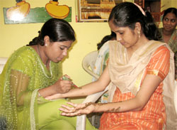 Students participate in a mehndi competition held at a private college in Bathinda