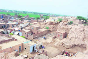 A view of the historical Theh Mound in Sirsa district. Several illegal houses have come up in the area.