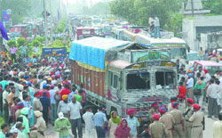 Residents block traffic on the GT Road after a truck ran over a schoolboy at Rama Mandi Chowk in Jalandhar
