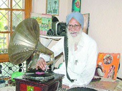 Balwant Singh shows his collection of gramophone records