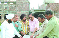 Deputy secretary, youth affairs and sports, D.P. Bharadwaj and assistant director, youth welfare, Capt I.S. Dhami inspect the underconstriction youth hostel at Burlton Park in Jalandhar