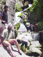 Students cross a river during a trekking camp at Manali.