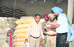 Officials from the health department seize sacks of adulterated wheat and gram flour during raids conducted  at flour mills in Ludhiana.