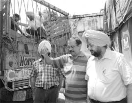 Civil surgeon Avtar Singh examines eatables seized from four trucks at Rajpura on Friday. 