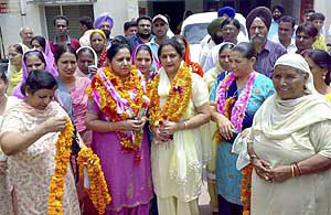 Newly elected president Manjit Kaur (garlanded right) and vice-president Seema Sharma at the municipal council office at Dera Bassi on Friday.