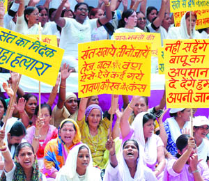 Supporters protest against remarks by the media and religious leaders at Jantar Mantar in New Delhi on Friday.