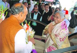 Chief Minister P.K. Dhumal welcomes Prabha Rao, the newly appointed Governor of Himachal, on her arrival at Raj Bhawan on Friday. 