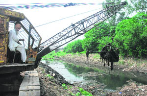 A dragline of the Drainage Department cleans the heavily silted East Bein, near Nakodar, on Friday. 